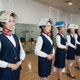 Students training to be flight attendants hold books on their heads and chopsticks in their mouths during posture practice at a vocational school in China in 2017.